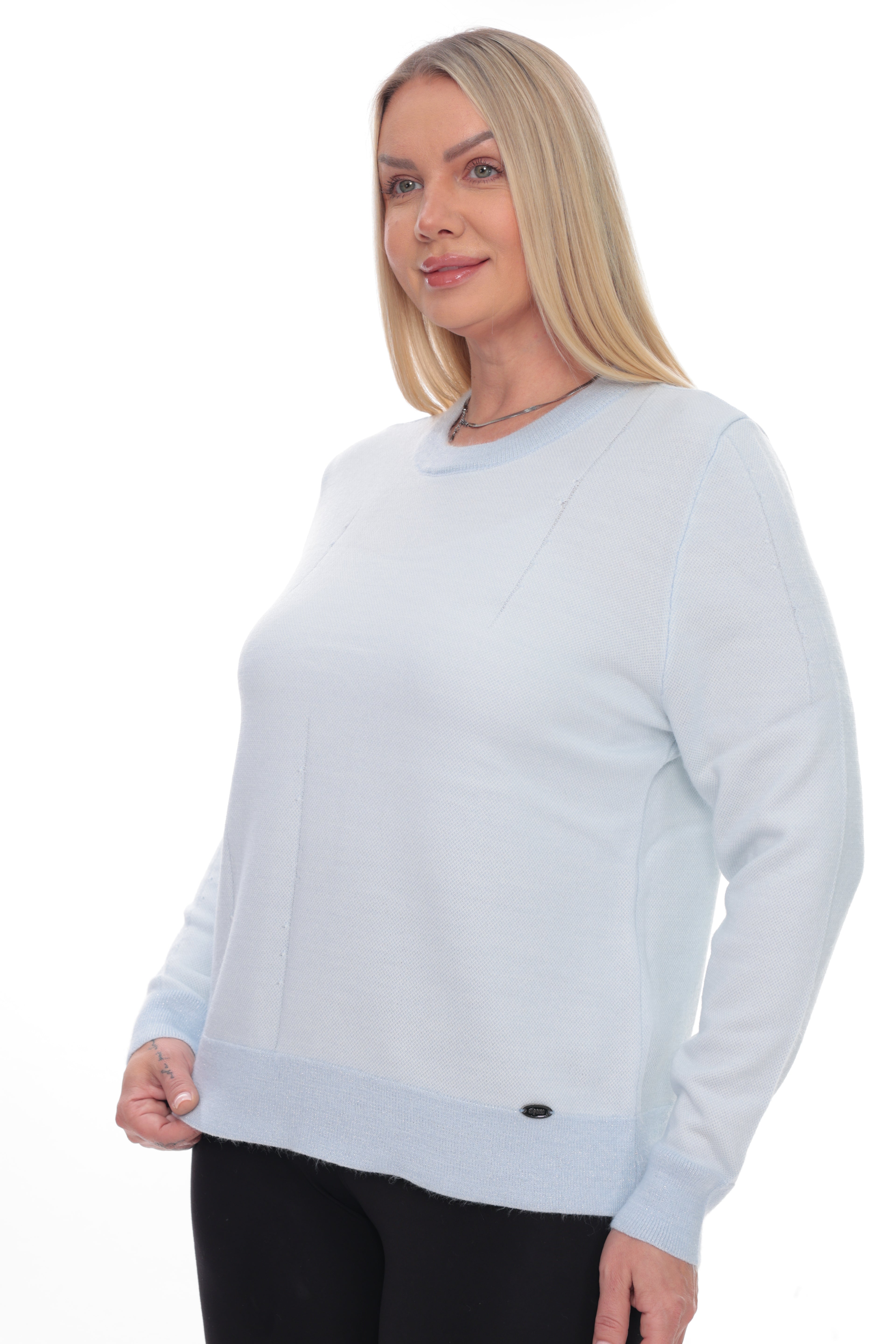 A blonde woman modeling a light blue long-sleeve crewneck sweater against a plain white background.