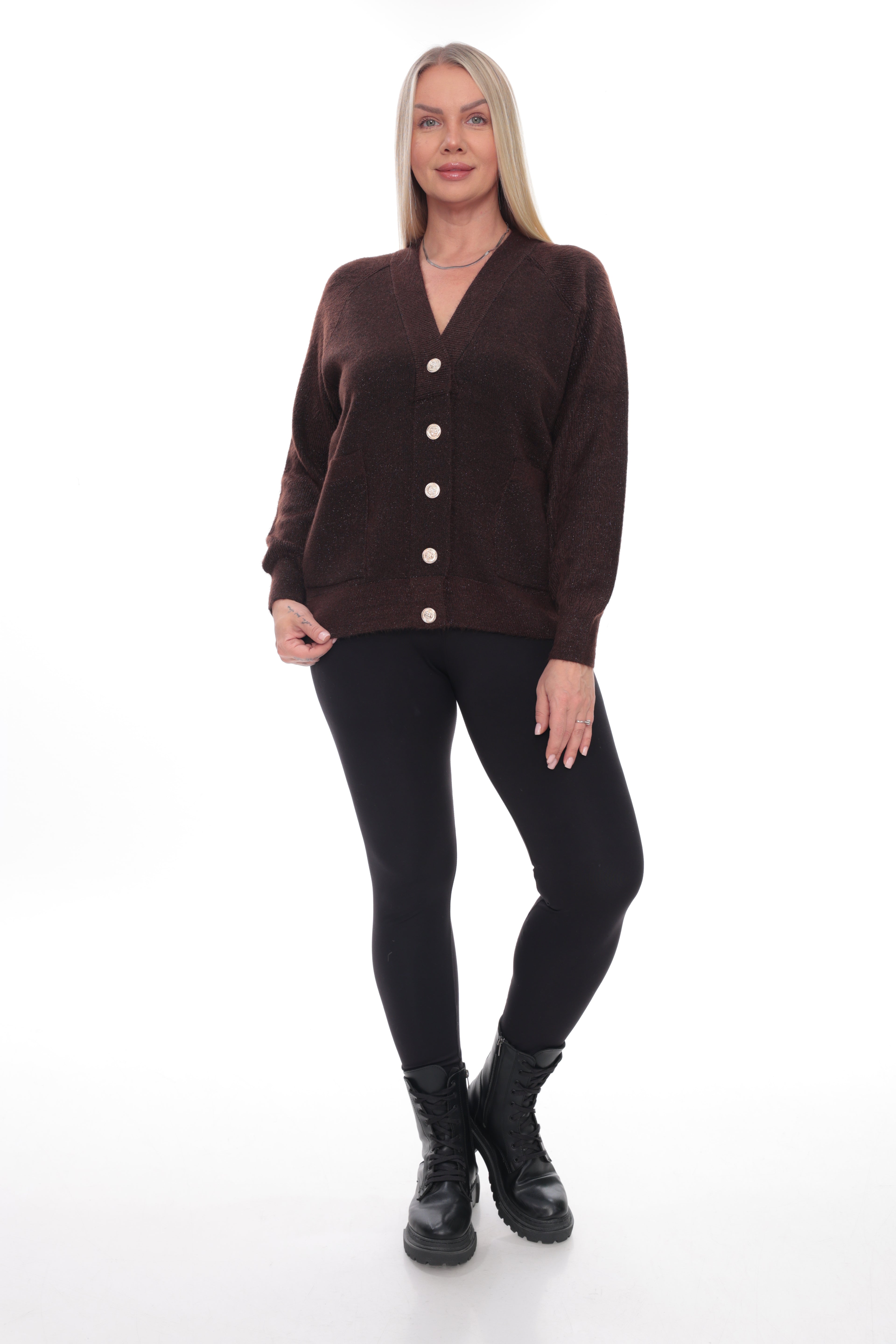 A woman modeling a dark brown button-up cardigan sweater with black leggings and black boots, standing against a plain white studio background.