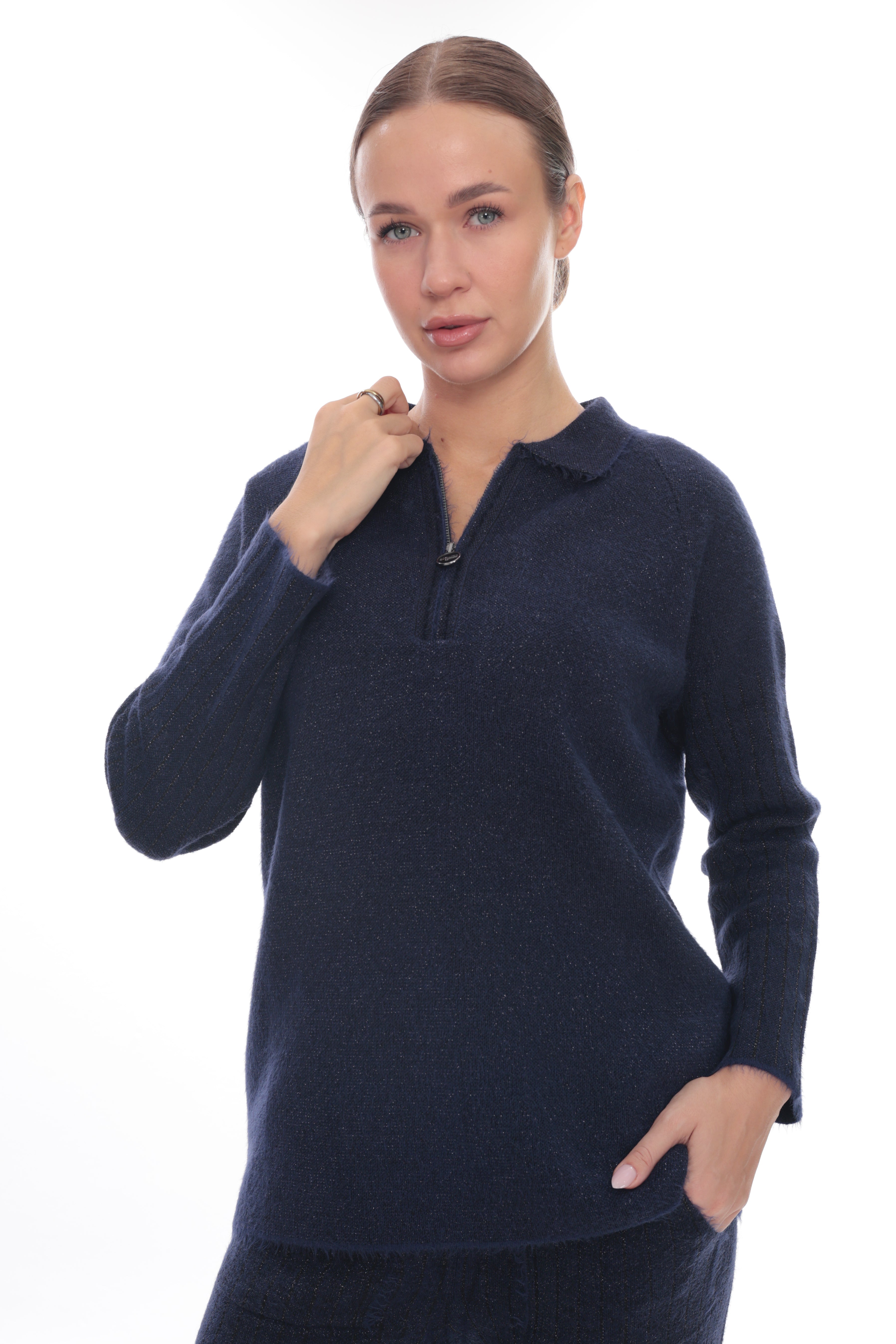 A woman modeling a dark navy blue long-sleeve knit polo-neck sweater with a short zipper at the collar, shown against a plain white background.