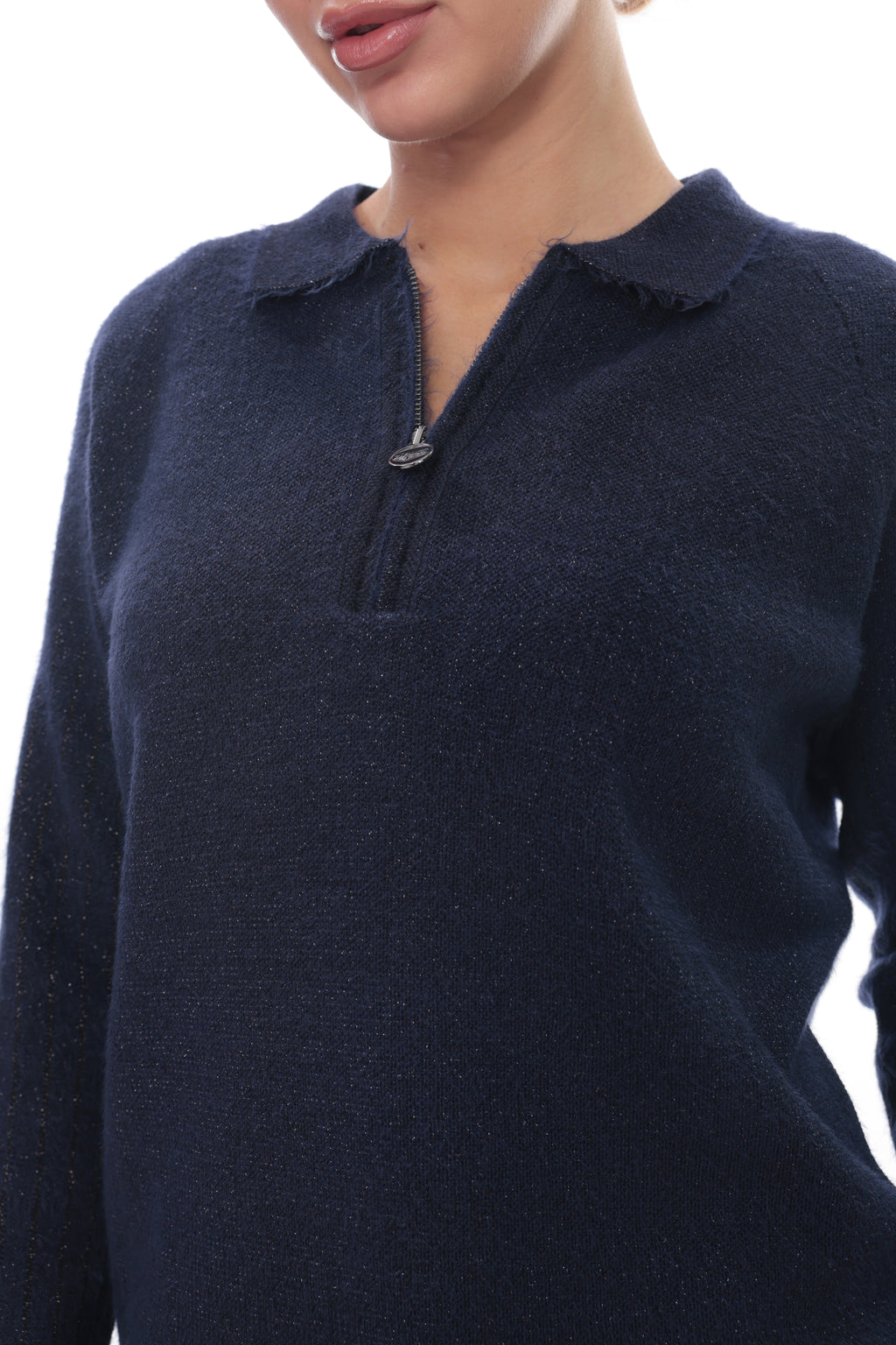 A close-up of a person wearing a dark navy knit sweater with a short zip neckline and a frayed collar, against a plain white background.