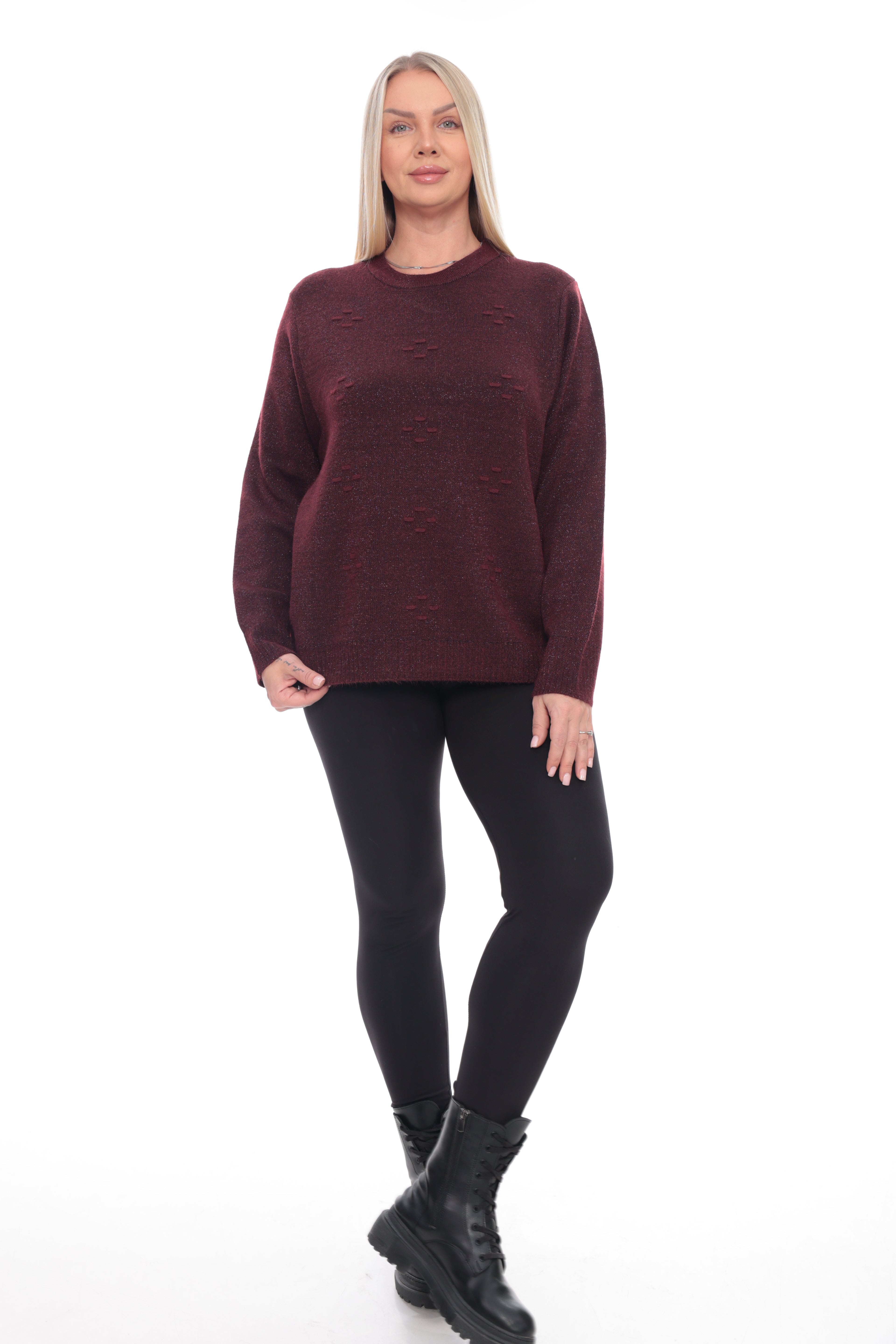 A woman modeling a dark burgundy knit crewneck sweater, paired with black leggings and black lace-up boots, against a plain white studio background.