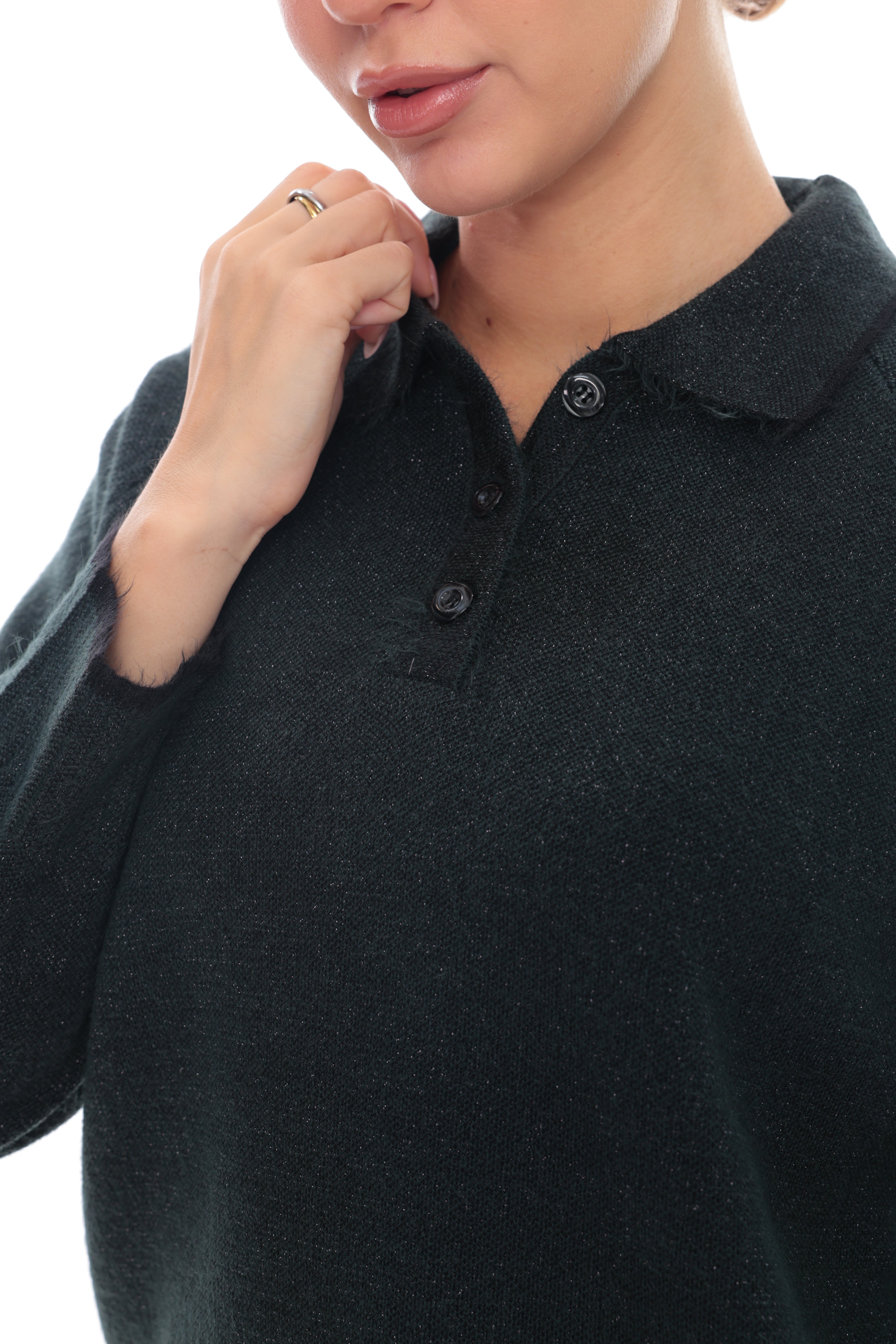 Close-up of a person wearing a dark charcoal knit polo sweater, showing the collar, buttons, and textured fabric against a plain white background.