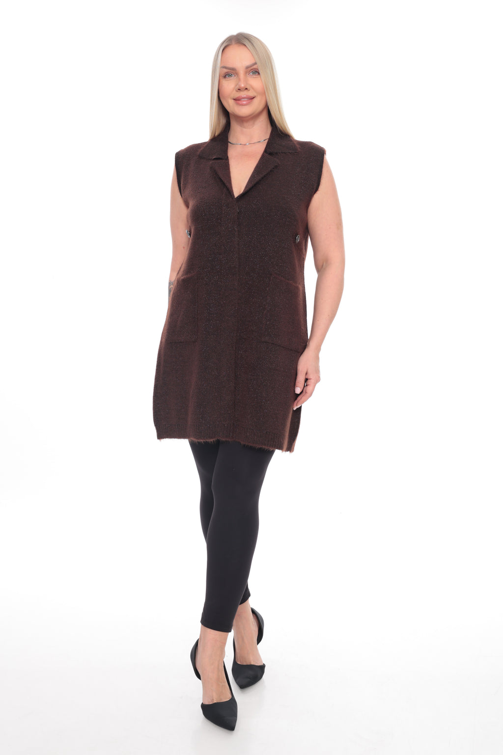 A woman modeling a sleeveless dark brown textured vest with a notched lapel and front buttons, paired with black leggings and black pointed-toe heels, against a plain white studio background.