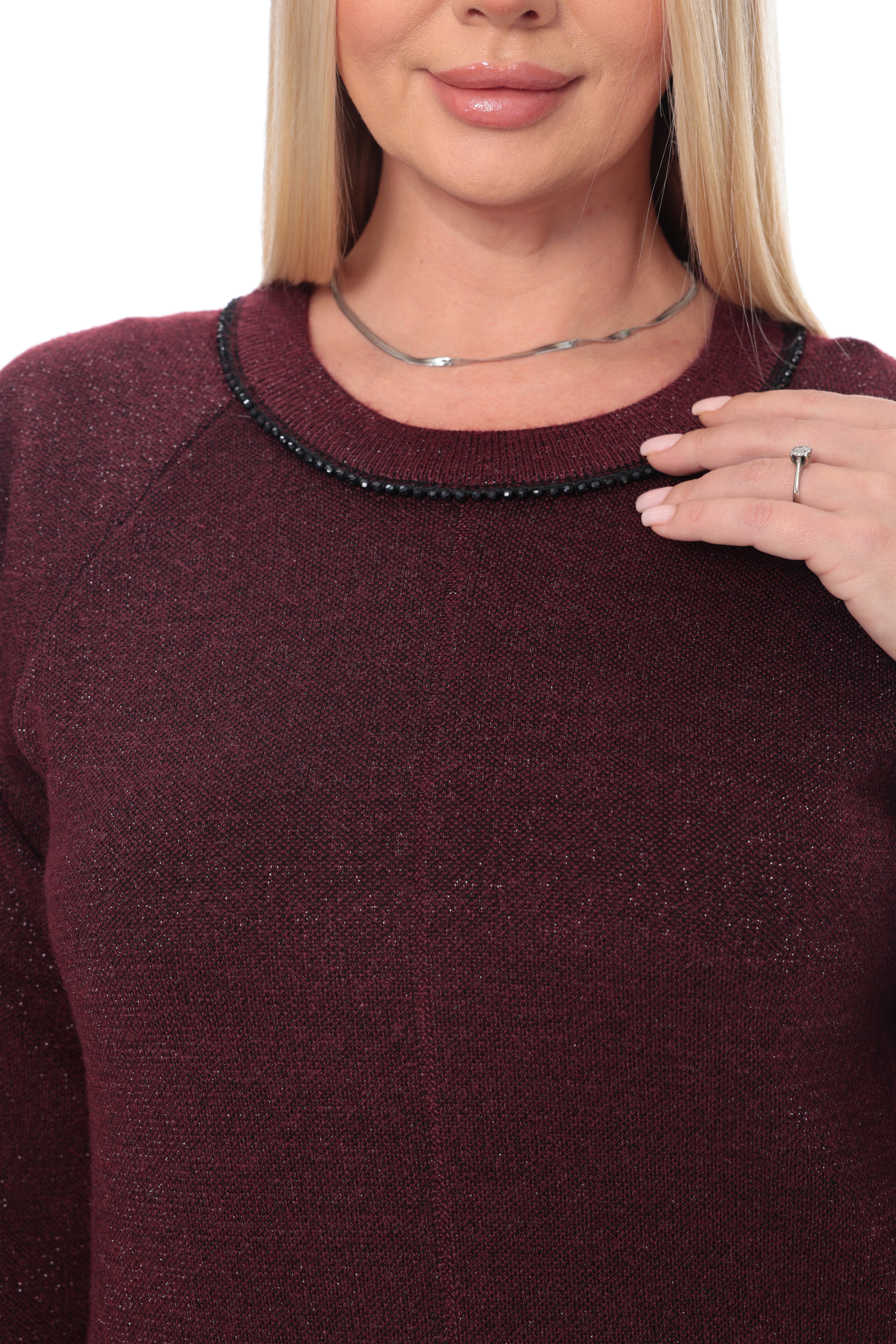 A woman modeling a long-sleeve knit midi dress in a deep burgundy color,  against a plain white studio background.