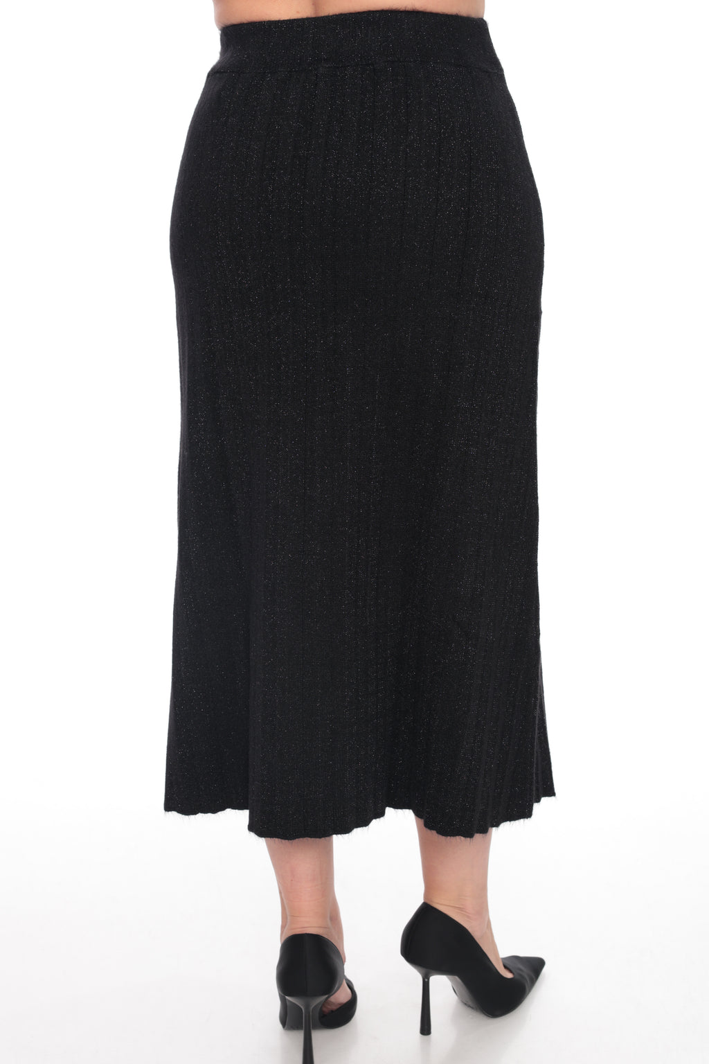 A black textured midi skirt shown from the back on a model, paired with black pointed-toe heels, against a plain white background.