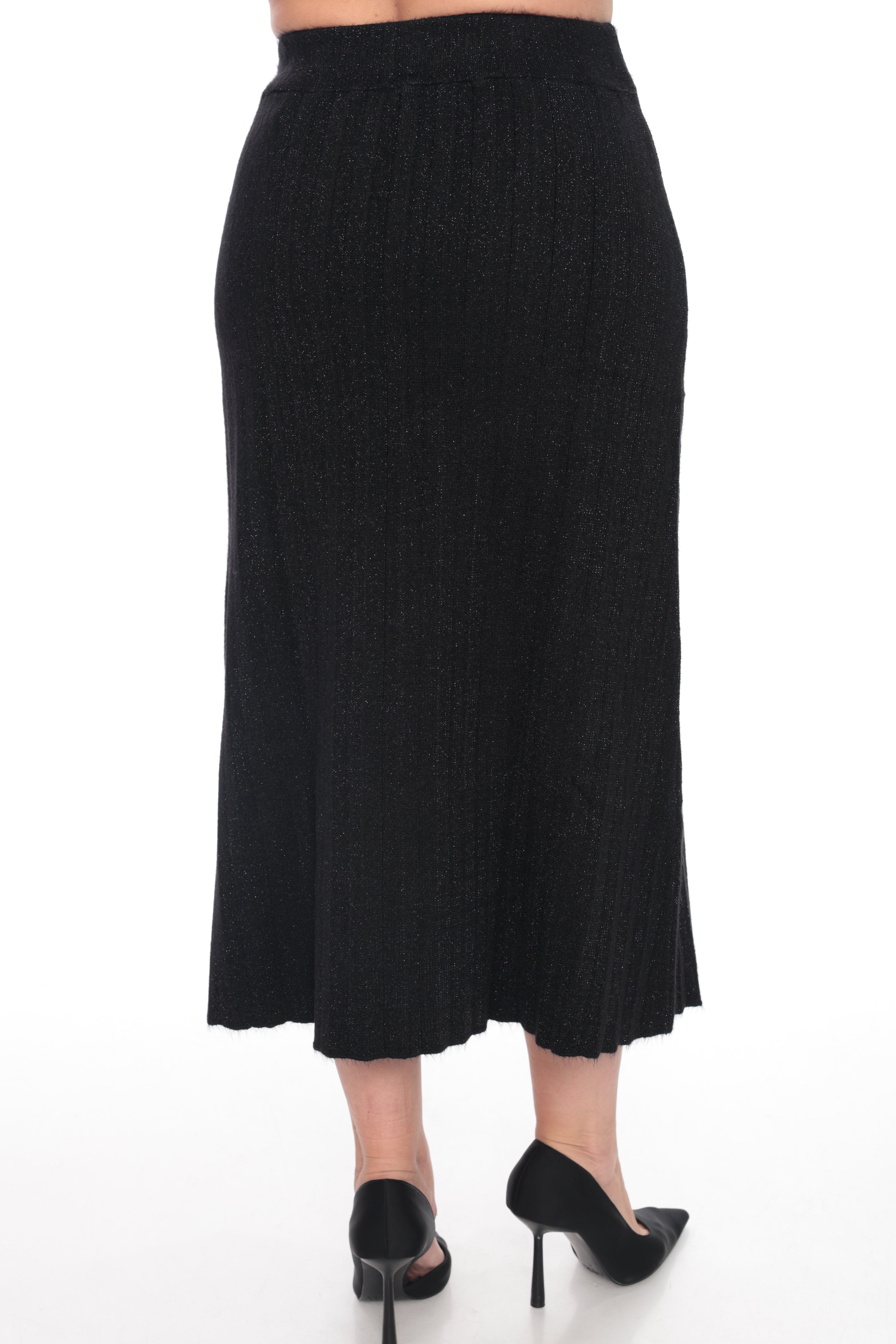 A black textured midi skirt shown from the back on a model, paired with black pointed-toe heels, against a plain white background.