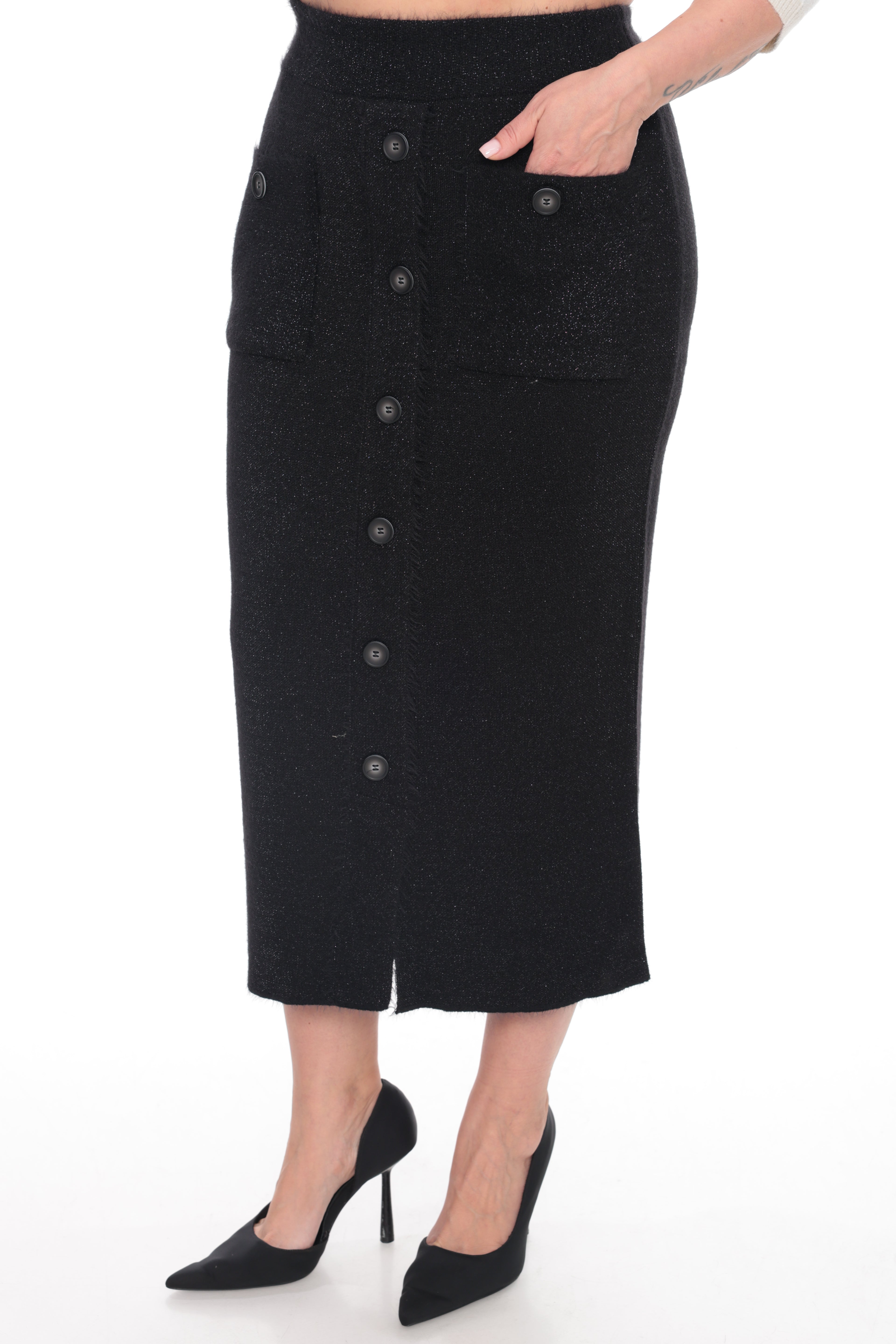 A black textured midi skirt with a button-front closure and side pockets, shown on a model wearing black pointed-toe heels against a white studio background.